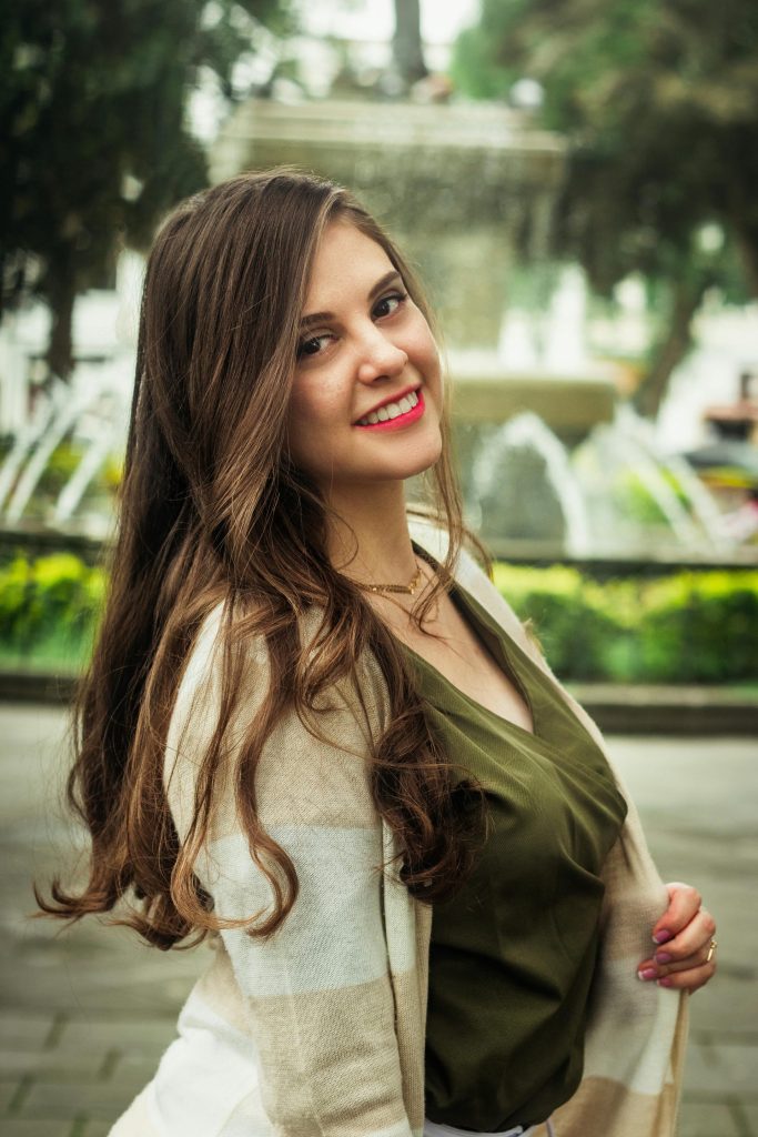 Woman in Green Blouse and Striped Cardigan